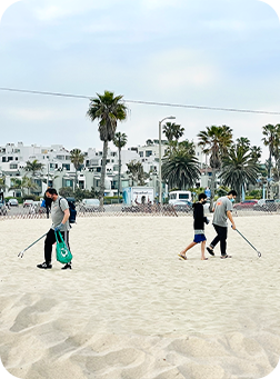 People Picking Up Trash on a Beach in Santa Monica Beach, California